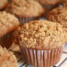 muffins cooling on a wire rack with some crumbs in the middle