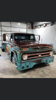 an old truck is parked in a garage