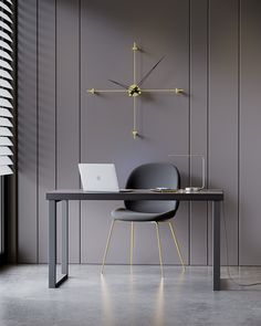 a laptop computer sitting on top of a wooden table next to a wall mounted clock