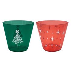 two glass cups decorated with christmas trees and snowflakes, one green and the other red