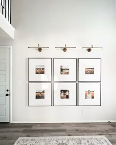 four framed photographs hang on the wall above a rug