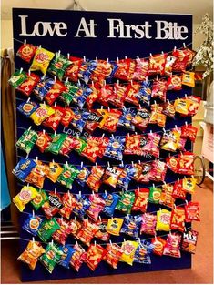 a large display of love at first bite candies in front of a sign that says love at first bite