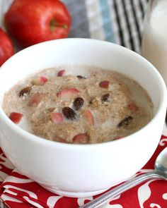 a bowl of oatmeal with apples and milk