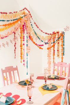 the table is set with plates and place settings