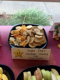 a table topped with lots of different types of crackers next to a sign that says super star