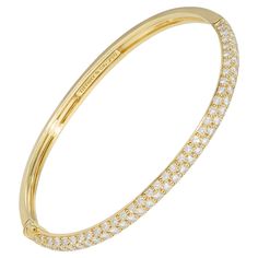 Tiffany diamond bangle in 18 karat gold is a must-have everyday accessory for the jewelry lover. This sleek and modern bangle is part of Tiffany’s admired Metro collection. The elegant design sparkles with three perfectly streamlined rows of top-quality round-brilliant diamonds (F to G color, VVS to VS clarity) which total a substantial 4 carats. Lustrous yellow gold serves as the perfect backdrop that enhances the glitter of the diamonds. The bangle is hinged and perfectly conforms to the shape Tiffany Bangle, Vintage Diamond Bracelet, Vision Manifestation, Modern Bangle, Tiffany Diamond, Bracelet Tennis, Yellow Gold Bangle, Modern Bracelets, Louis Comfort Tiffany