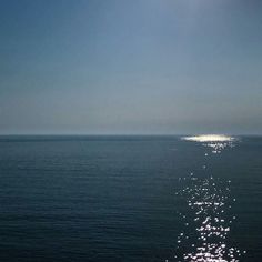 the sun shines brightly on the water as it reflects off the ocean's surface