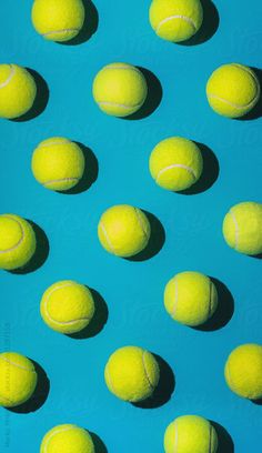 many tennis balls are arranged in rows on a blue surface by julia radwig for stocks & bonds