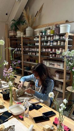 a woman is working in a flower shop