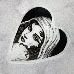 a black and white drawing of a woman's face in a heart shaped hole