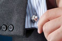 a close up of a person wearing a suit and tie with dice on his lapel