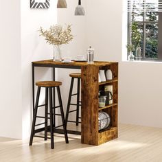 two stools and a table in a white room with wood flooring on the side