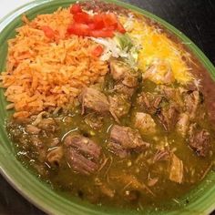 a green plate topped with meat and rice