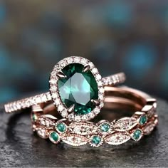 two wedding rings with green and white stones