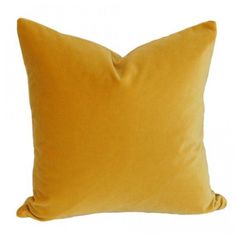 a yellow pillow on a white background