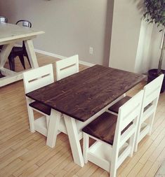 a wooden table and chairs in a room with hard wood flooring on the ground