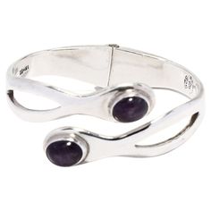 This stunning vintage Mexican sterling silver bangle bracelet will make a stunning addition to any jewelry collection! Crafted from sterling silver, this gorgeous bangle bracelet features 6.9ctw of amethysts. The bracelet is hinged for easy on and off, and measures 6.25 inches in length. Perfect for adding a luxurious touch to any ensemble, this Mexican silver jewelry makes an excellent gift for any occasion. Let this Vintage Mexican 6.9ctw Amethyst Bangle Bracelet in Sterling Silver be the stan Fine Jewelry Gemstone Cuff Bracelet For Formal Occasions, Formal Fine Jewelry Cuff Bracelet With Gemstone, Formal Gemstone Cuff Bracelet, Spiritual Bangle With Sterling Silver Clasp, Classic Gemstone Bangle Jewelry, Hallmarked Silver Fine Jewelry Bangle, Formal Hallmarked Cuff Bangle Bracelet, Elegant Silver Open Band Bracelets, Anniversary Sterling Silver Bangle With Silver Clasp