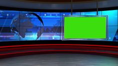 a television set with a green screen in front of the news desk and two monitors on each side