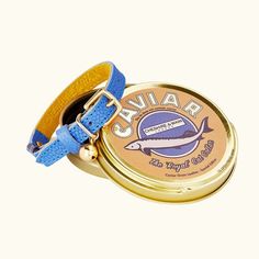 a small tin with a blue strap around it