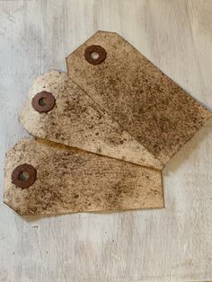 three pieces of brown paper with holes in them