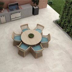 an aerial view of a table and chairs in the middle of a patio with grills