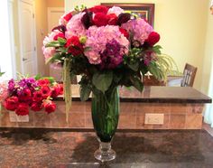 a vase filled with flowers sitting on top of a counter