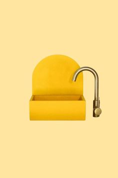 a yellow chair with a metal faucet on it's back and side