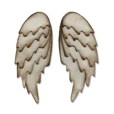 two white angel wings are shown on a white background, one is cut out and the other has been made from wood