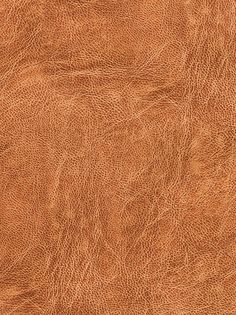 a brown leather texture background or wallpaper that looks like it has been used for many years