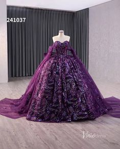 a purple ball gown is on display in front of a curtained window with curtains behind it