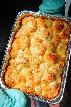 a person holding a tray with some food in it