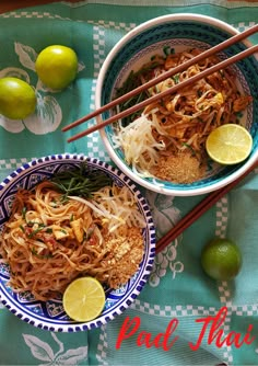 two bowls of pad thai noodles with limes and chopsticks on the side