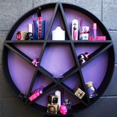 a shelf with various items on it in the shape of a pentagram