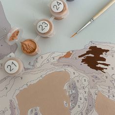 some paint sitting on top of a map