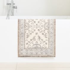 a white bath tub sitting next to a rug