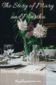 the table is set with plates, glasses and flowers in vases on top of it