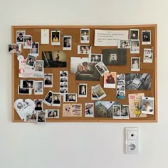 a cork board with pictures and magnets on it