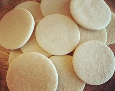 several round cookies sitting on top of a wooden table