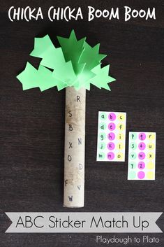 a tree made out of paper next to some letters and numbers on a wooden table