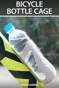 a bottle of water sitting on top of a yellow and black surfboard with the words bicycle bottle cage above it