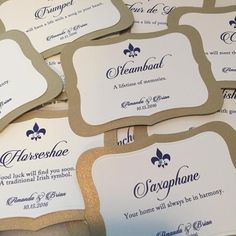 several business cards with fleur de lys written in blue and gold on them