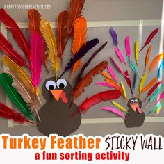 a turkey feather sticky wall with a fun sorting activity for kids to do on thanksgiving