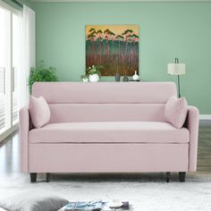 a living room with green walls and a pink couch in front of a painting on the wall