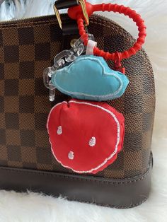 a handbag with an animal keychain attached to it