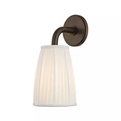 a wall light with a white pleated shade on the side and a brown arm