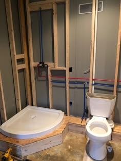 an unfinished bathroom with a white toilet and bathtub in the process of remodeling