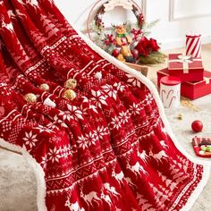 a red and white christmas blanket on the floor