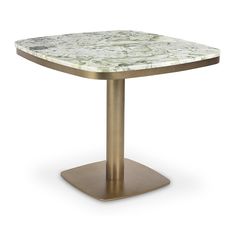 a white marble table with gold metal base and an oval shaped center piece on the top