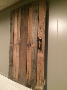 a bathroom with a wooden door on the wall