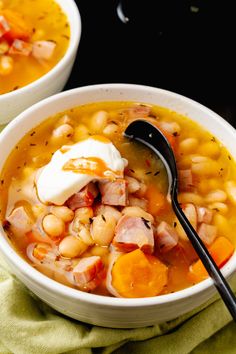 two bowls filled with soup and topped with sour cream